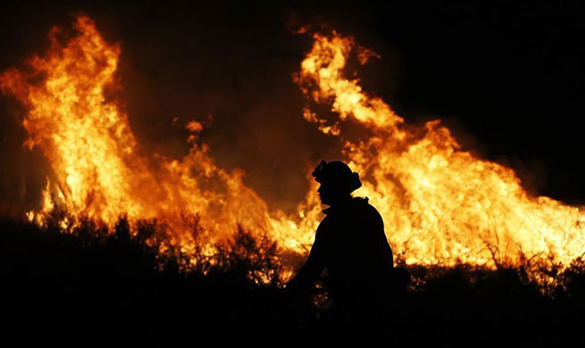 Dozens of wildfires burn across California